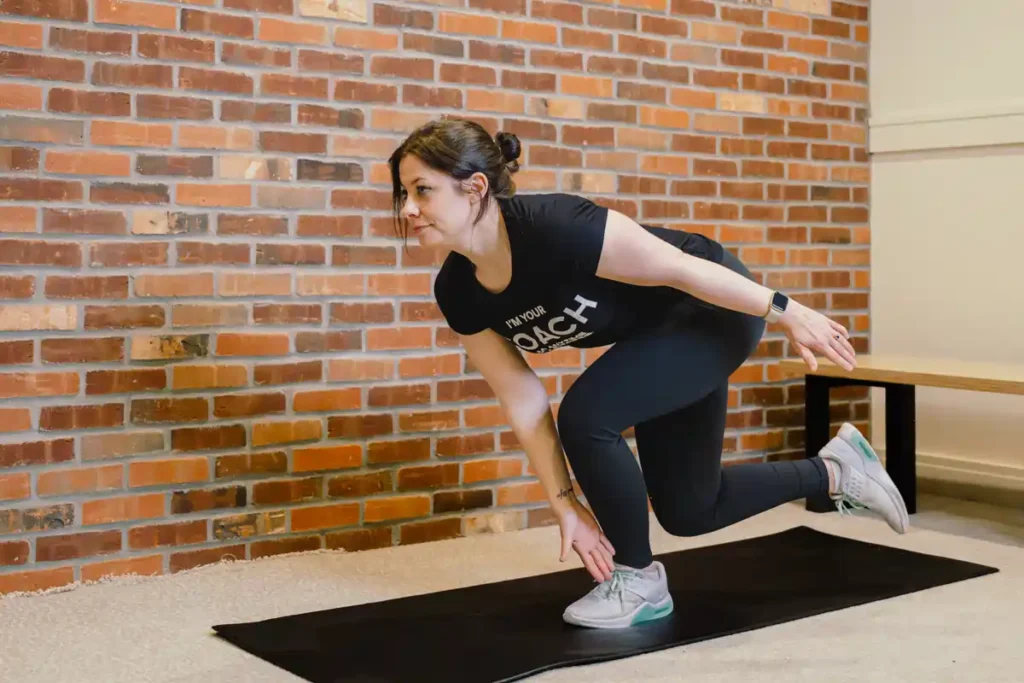 A person exercising their arms at home with light weights Bagshot