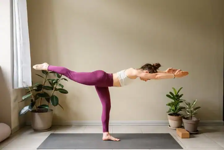 Woman doing Yoga exercise Bagshot to help with toning the body. 